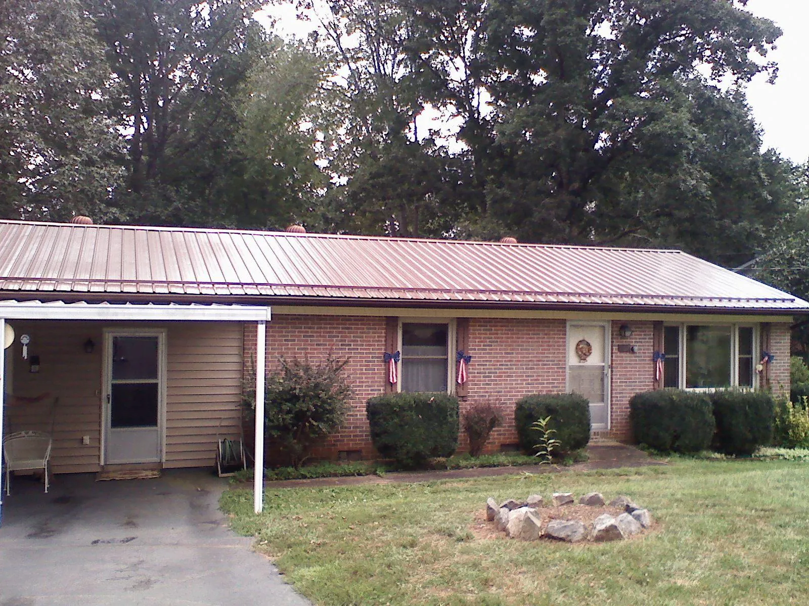 Bronze metal roof and carport on a brick ranch home — Roof Repair work by our crew in Pacific Grove